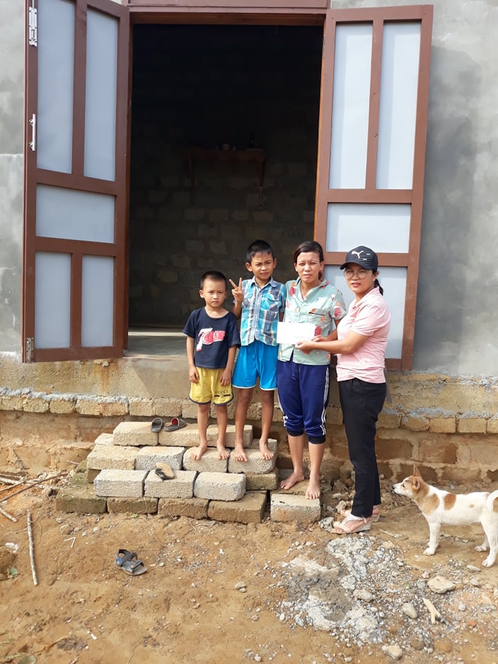 poor family in front of their new home