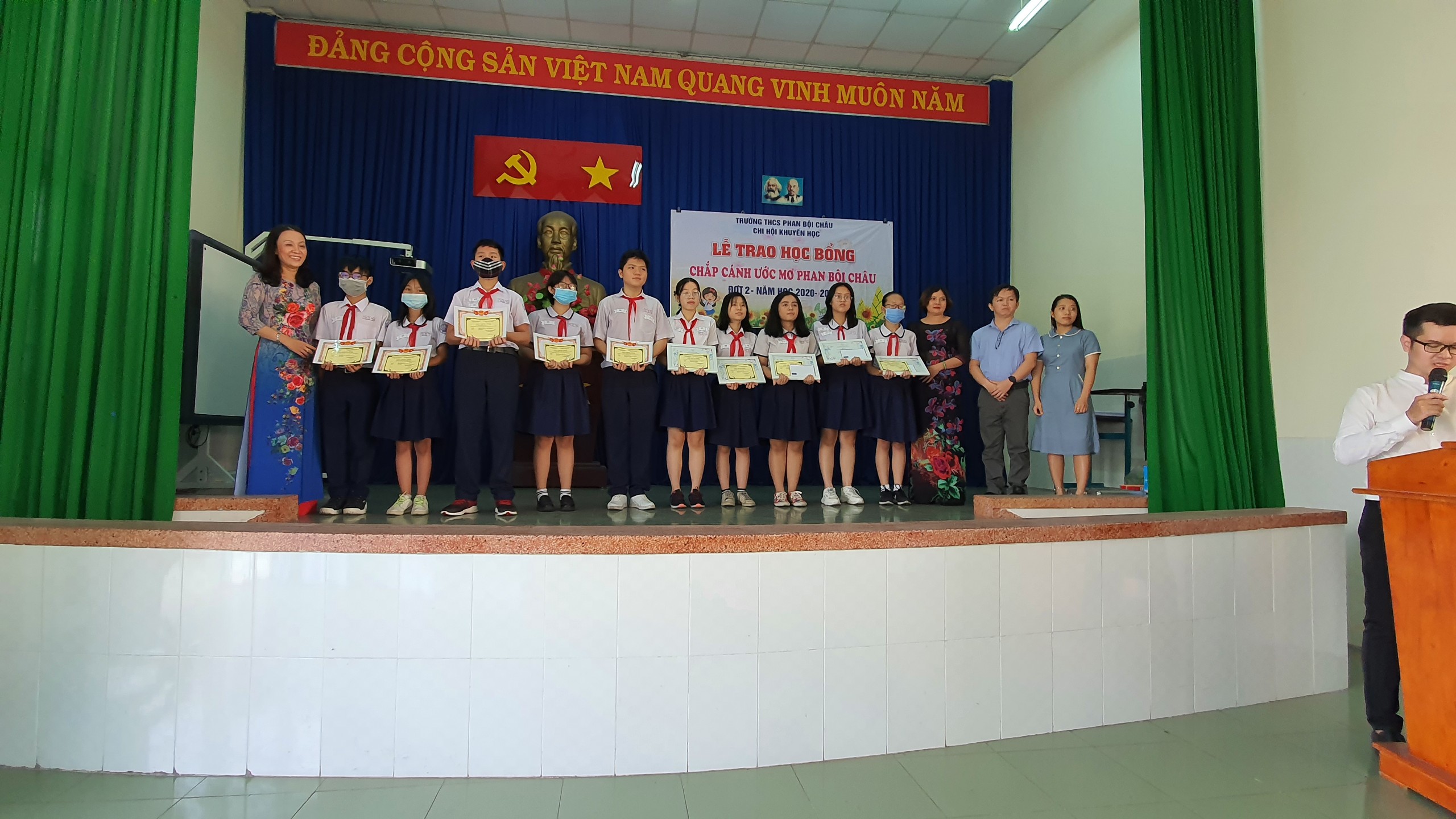 Students receive certificates of merit in the auditorium